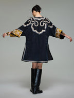 Back view of the loose Xiangyunsha silk dress showing ornate shoulder embroidery and wide three-quarter sleeves