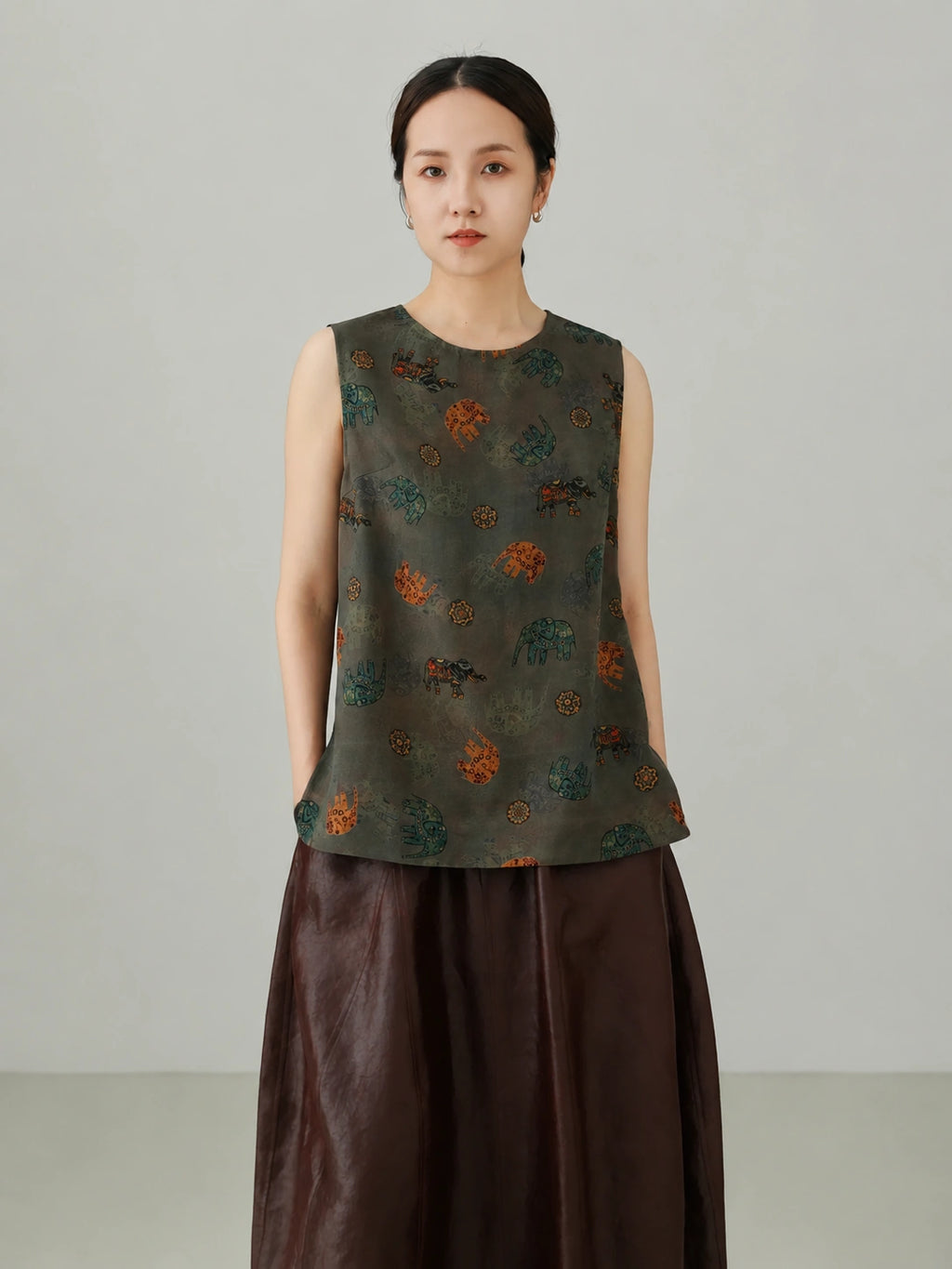 Close-up view of Xiangyunsha mulberry silk vest top featuring traditional elephant pattern print and premium silk texture