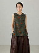 Close-up view of Xiangyunsha mulberry silk vest top featuring traditional elephant pattern print and premium silk texture