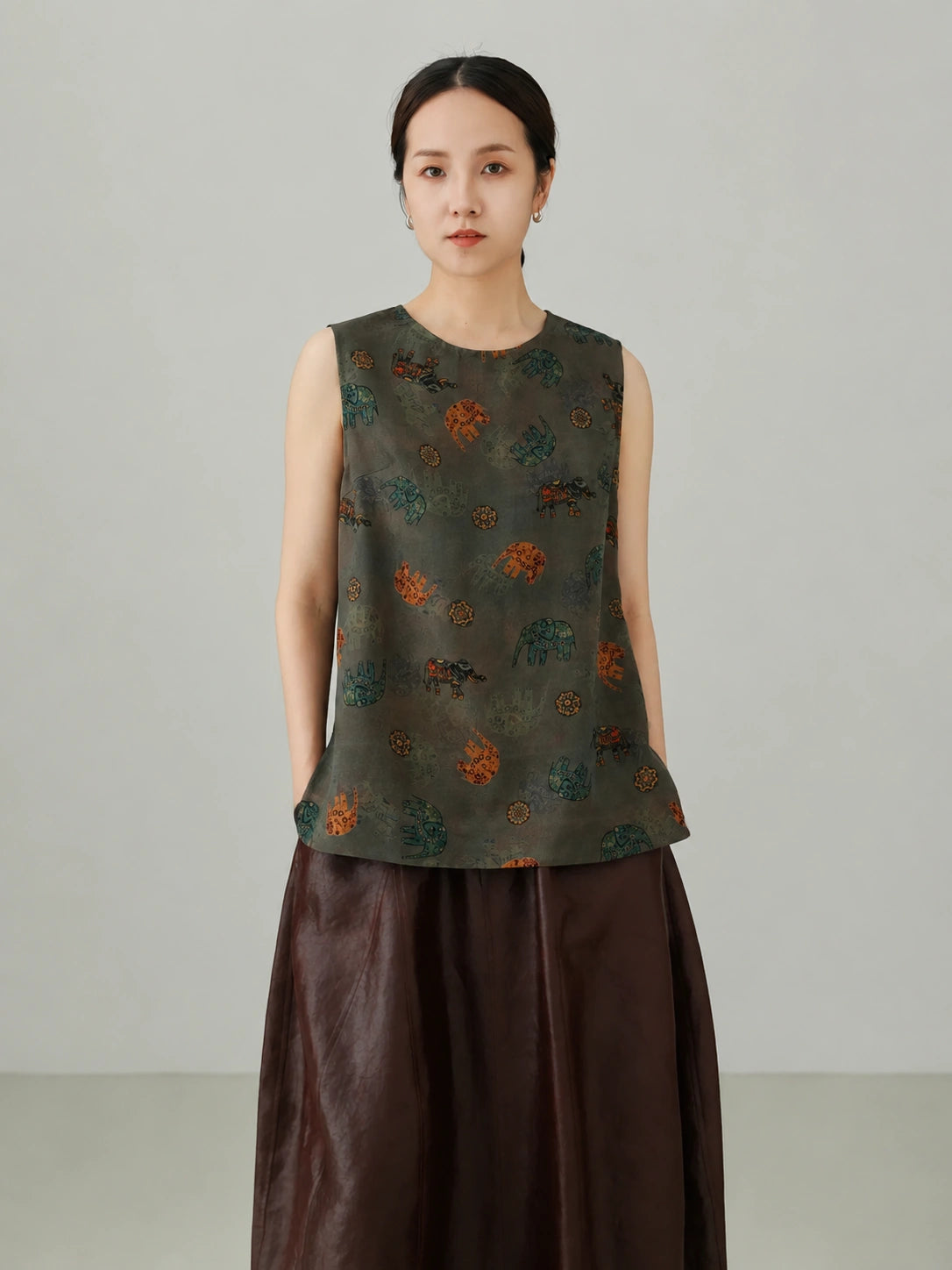 Close-up view of Xiangyunsha mulberry silk vest top featuring traditional elephant pattern print and premium silk texture