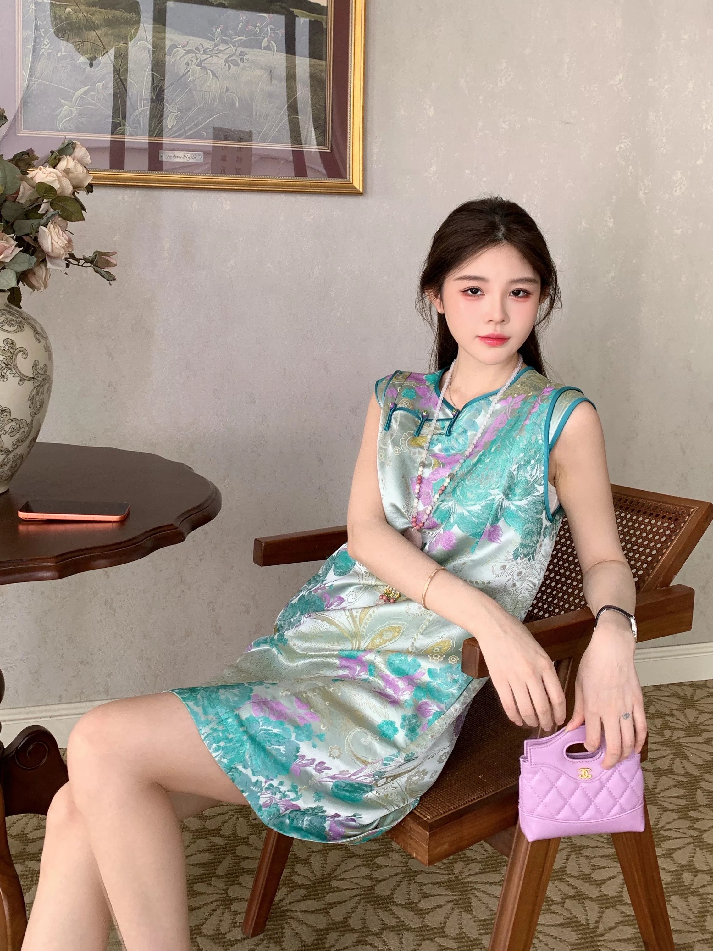 Close-up of the Xiaolan floral dress with turquoise and lavender flowers and traditional front details