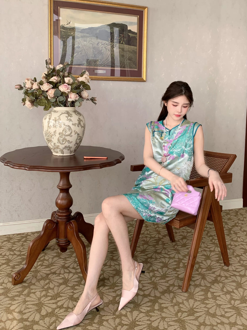 Model seated in the Xiaolan floral new Chinese dress, showing the stand collar and A-line silhouette