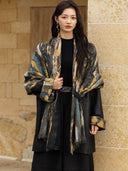 Front detail of the Xuye black leather jacket with a patterned cashmere shawl panel draped around the shoulders