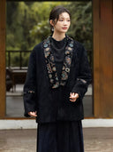 Model wearing the Yanchuan black jacquard jacket with colorful embroidered neckline panels and sleeve bands.