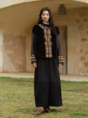 Yanrong embroidered down jacket styled with black wide-leg trousers and brown flats outdoors