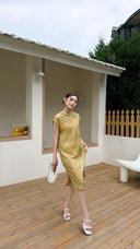 Full body shot of a yellow midi Cheongsam dress with cap sleeves and a button-up front, perfect for summer garden parties.