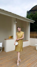 Full body shot of a yellow midi Cheongsam dress with cap sleeves and a button-up front, perfect for summer garden parties.