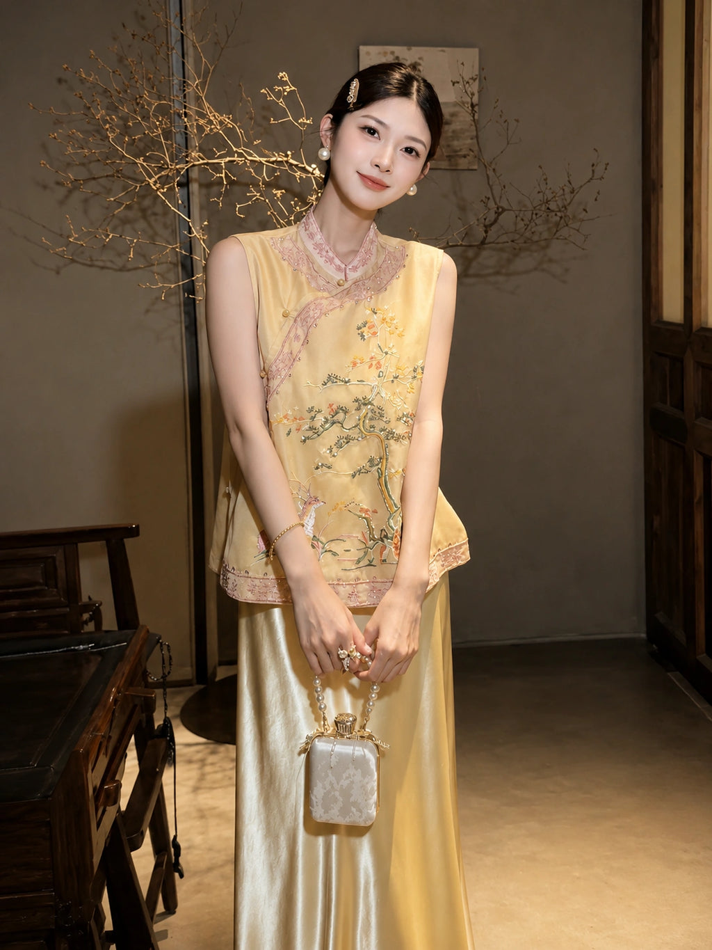 Front view of a yellow embroidered vest with traditional floral embroidery, styled with a matching yellow skirt and handbag, crafted from 100% polyester.