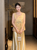 Model in a yellow sleeveless embroidered vest with a mandarin collar, holding a handbag, highlighting the intricate embroidery and elegant silhouette.