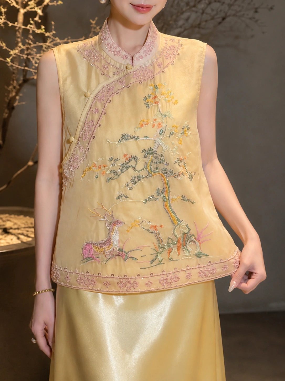 Side view of a yellow embroidered Cheongsam vest with a mandarin collar, styled with a yellow satin skirt, showcasing the comfortable fit and traditional details.