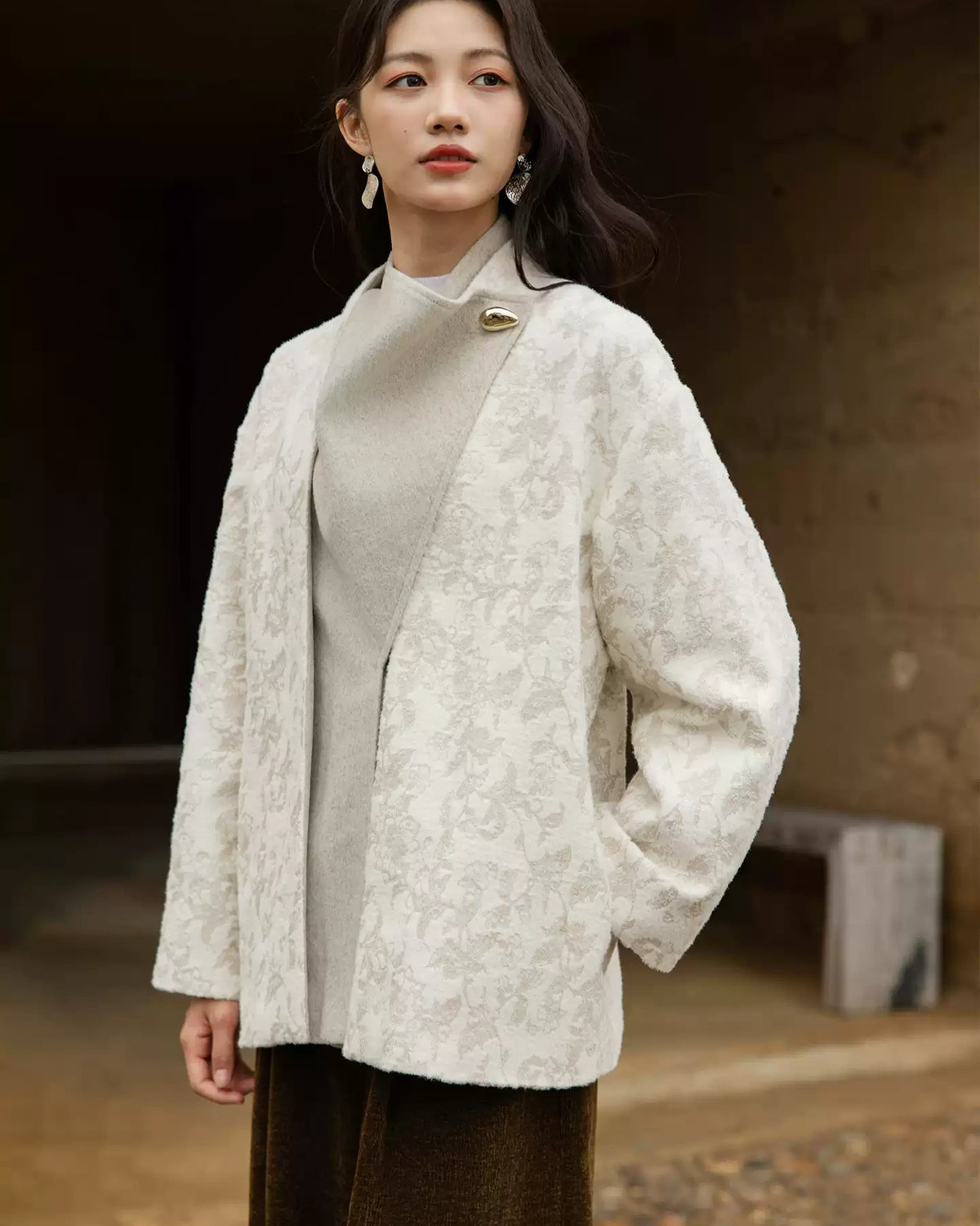 Yongyan ivory coat with the wool-blend front panel raised at the neckline, showing a gold-tone decorative accent
