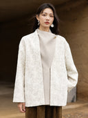 Front view of the Yongyan coat highlighting its textured ivory floral jacquard and contrasting wool-blend panel