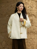 Front view of the Yuanting jacket showing floral jacquard, frog fastenings and golden turn-back cuffs.