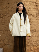 Front view of the Yuanting ivory jacket highlighting its gold-tone piping, three frog fastenings and contrast cuffs.