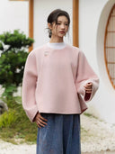 Yuyan cropped wool coat styled over a white top with blue patterned wide-leg trousers